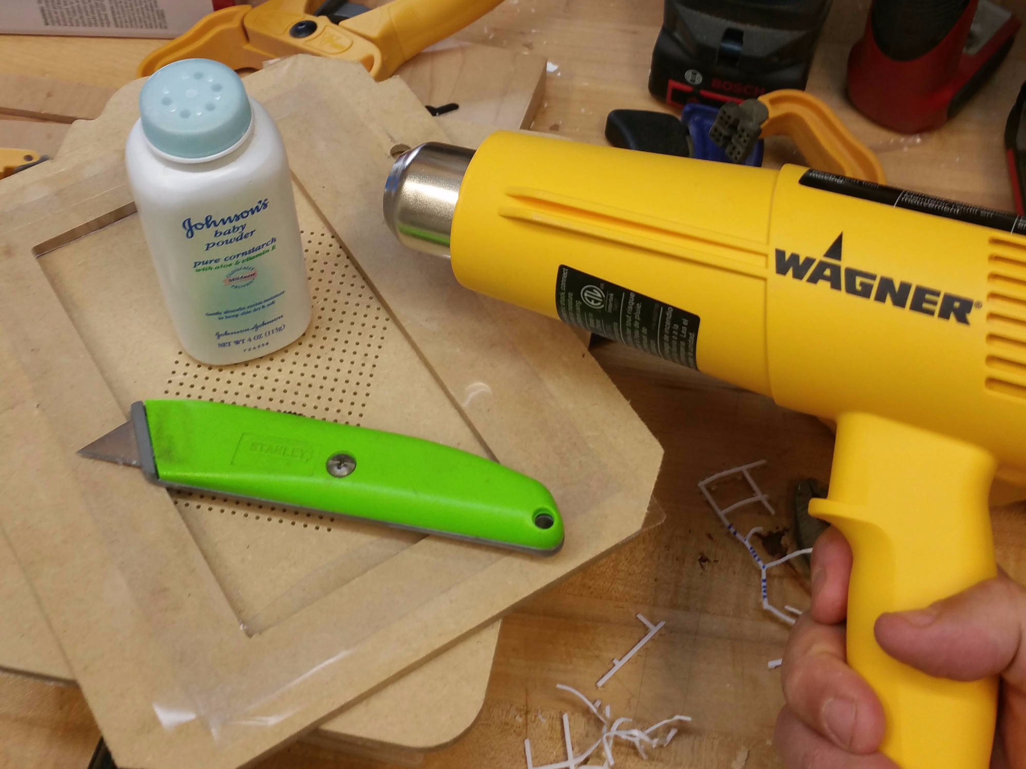 image of vacuum former top, baby powder, utility knife and heat gun