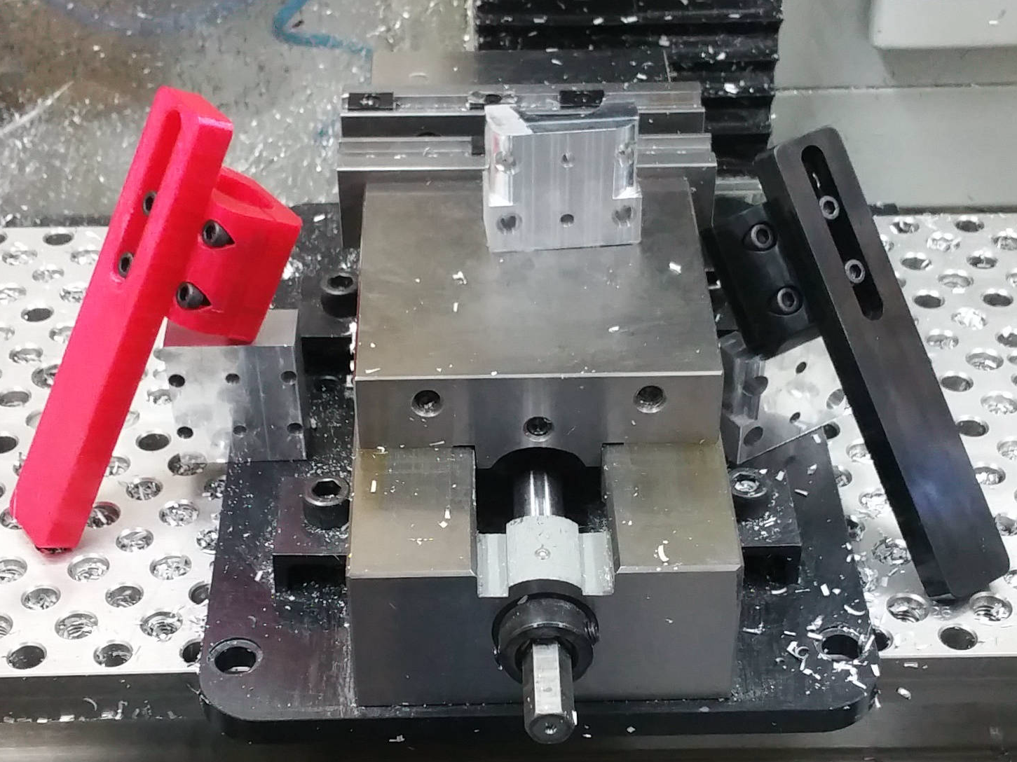 from left to right, 3d printed, mistake part, CNC vise, aluminum versions of Disability Lab wheelchair Anti-Tip Forward Bars